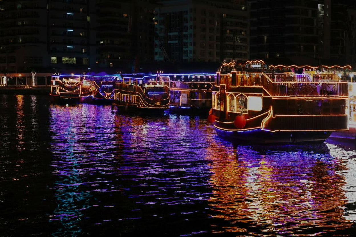 Promotional image for Dubai Marina Dhow Cruise Dinner featuring a vibrant nightscape of the Dubai Marina with a dhow boat, and textual information including the price and show details.