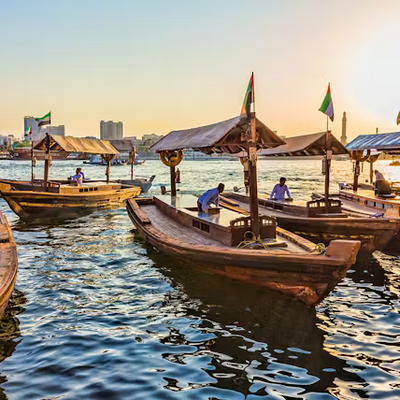 Traditional boats on a waterway with people and buildings in the background