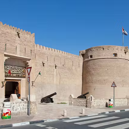 Historic fort with a minaret and clear blue sky